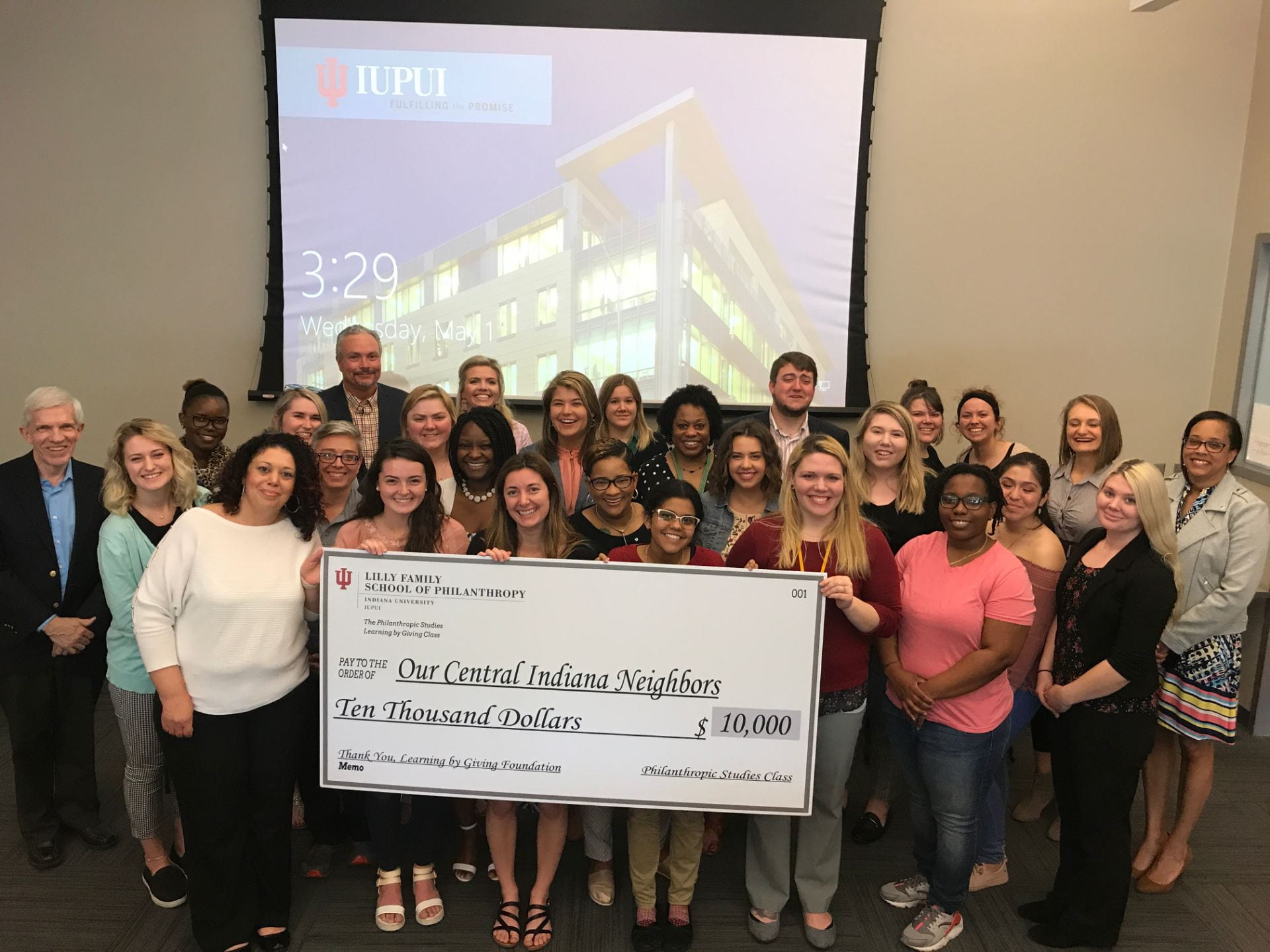Students present the check to PACE.