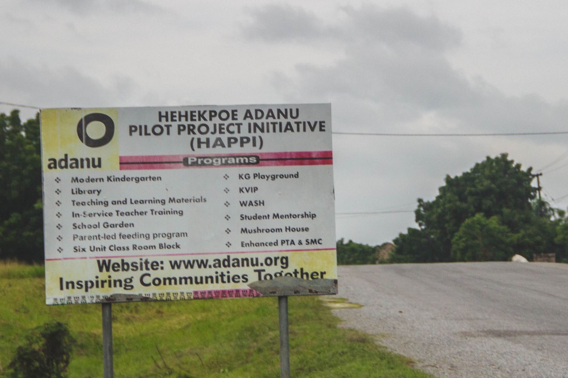 The sign outside of the village we visited. It lists the various projects the village is partnering with Adanu on. 