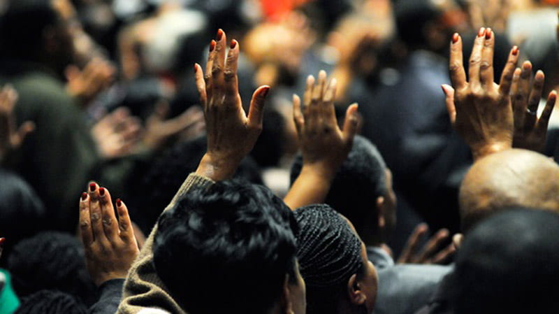 hands raised during church service