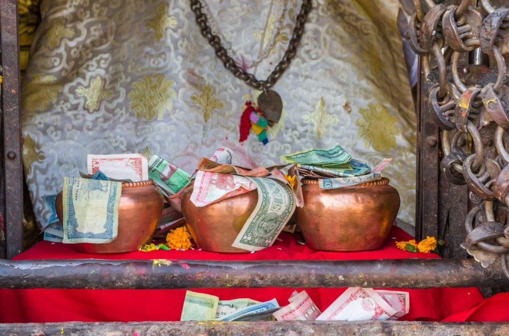 Bowls with donations at the Swayambhunath temple in Kathmandu, Nepal.